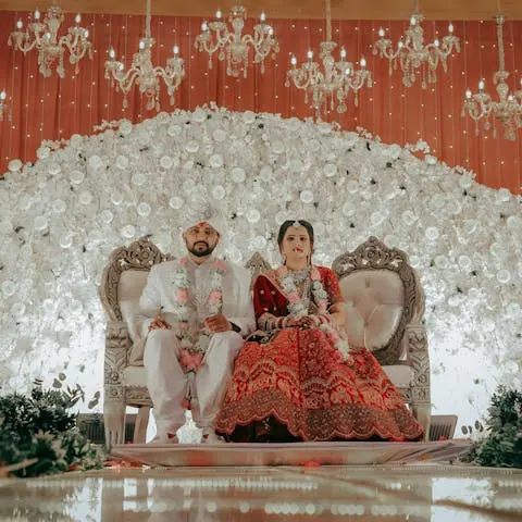 Elegant Indian wedding couple on an ornate stage
